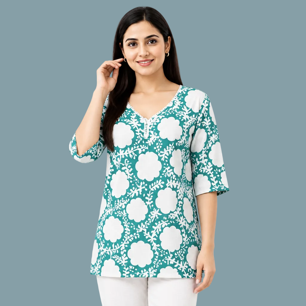 A woman wearing a teal and white floral print tunic top with three-quarter sleeves, shown against a plain white background.