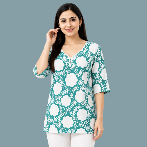A woman wearing a teal and white floral print tunic top with three-quarter sleeves, shown against a plain white background.