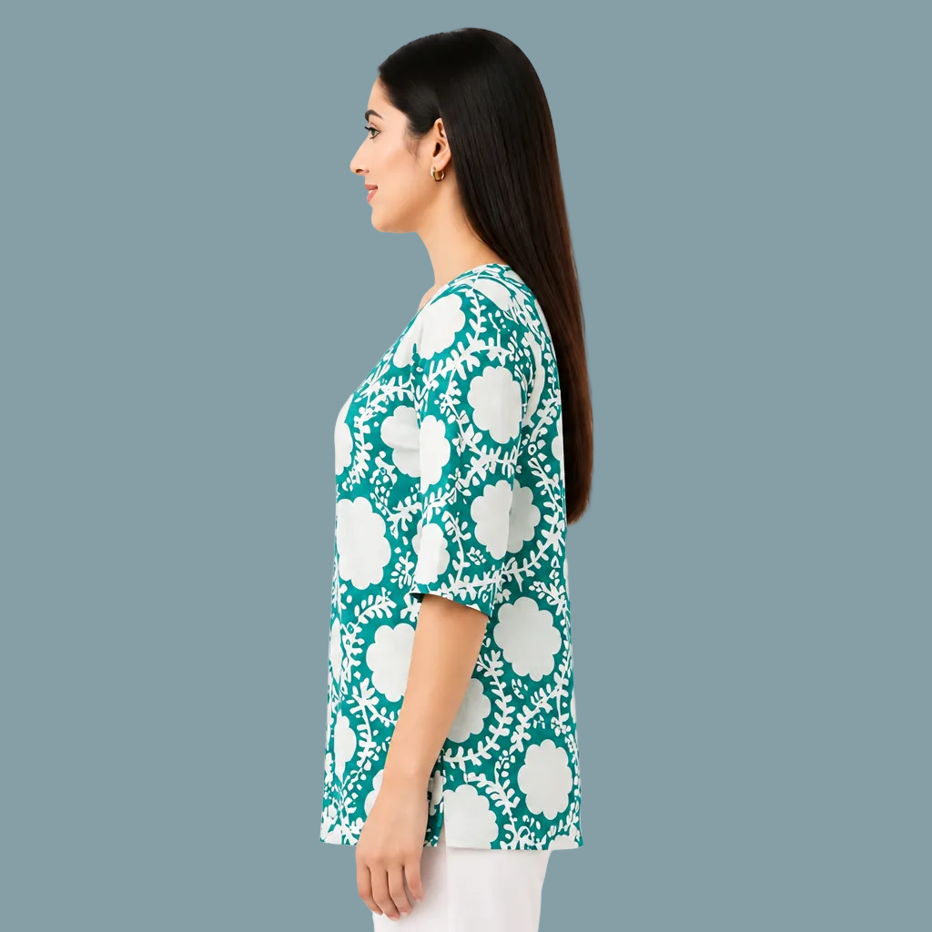 A woman shown in side profile wearing a teal and white floral print short-sleeve top against a plain white background.