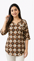 Model wearing a brown geometric printed cotton free size short kurti with 3/4 sleeves, lightweight breathable fabric, perfect for casual wear, office, college, and everyday fashion.
